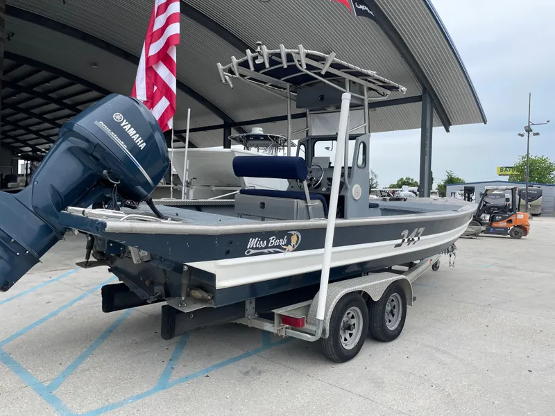 Slide: The Image of Hanko 247 boat from 2009 on trailer, featuring Yamaha engine and American flag. - 2