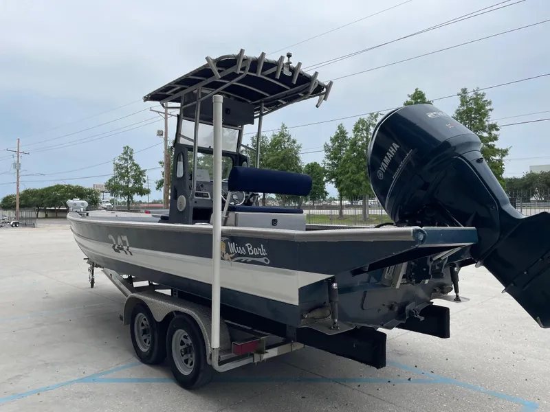 Slide: The Image of Hanko 247 boat on trailer, 2009 model, with Yamaha outboard motor, parked outdoors. - 3