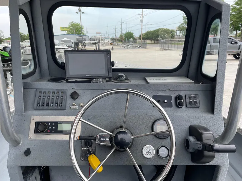 Slide: The Image of Control panel of a 2009 Hanko 247 boat with steering wheel and navigation equipment. - 8
