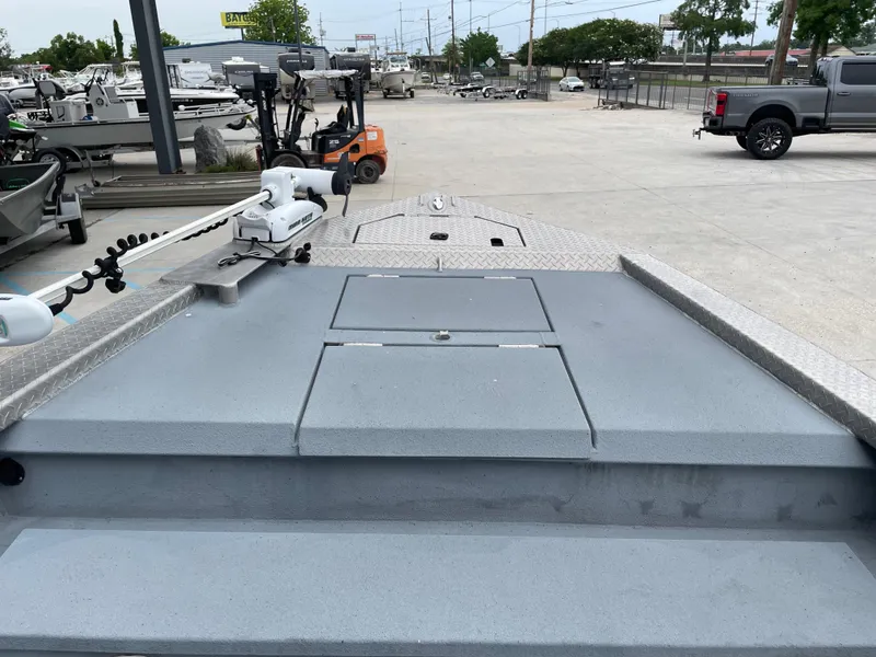 Slide: The Image of Bow of a 2009 Hanko 247 boat in a marina with equipment and vehicles. - 9