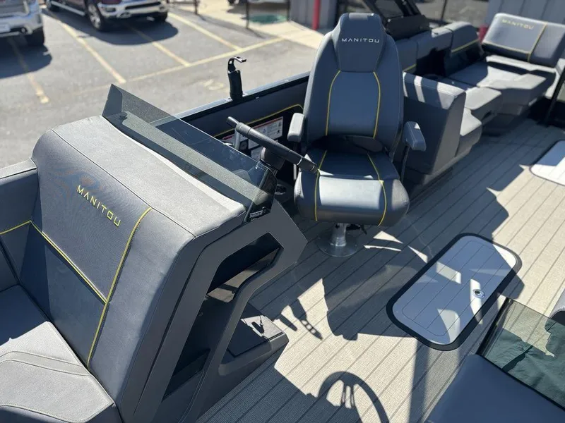 Slide: The Image of 2023 Manitou Explore 22 Max Bench boat interior with sleek seating and modern design. - 13