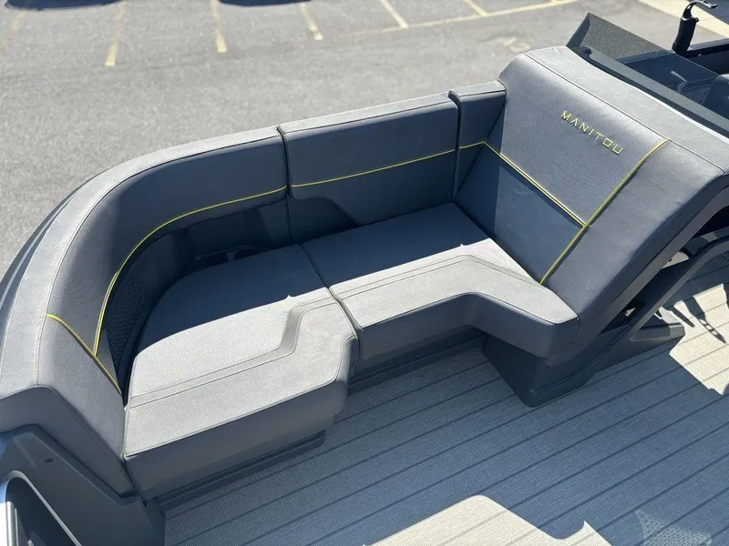 Slide: The Image of 2023 Manitou Explore 22 Max Bench with sleek gray seating and yellow accents. - 14