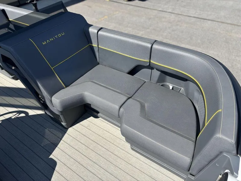Slide: The Image of 2023 Manitou Explore 22 Max Bench with sleek gray seating and yellow accents. - 15