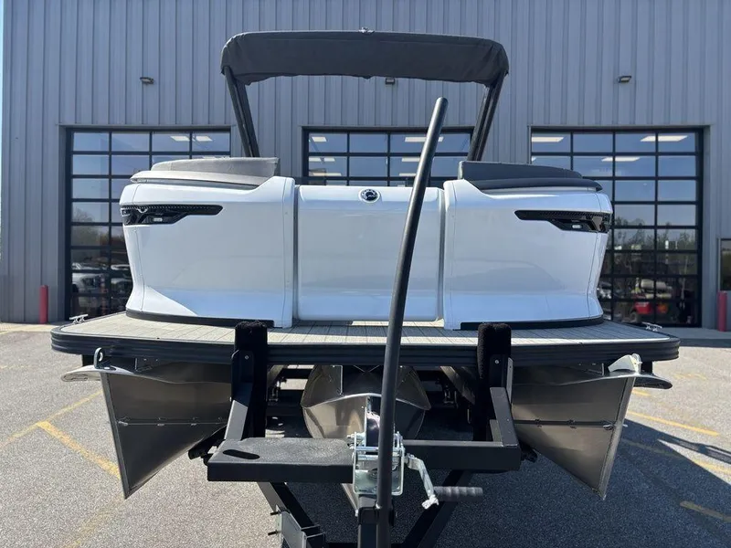 Slide: The Image of 2023 Manitou Explore 22 Max Bench pontoon boat on trailer, rear view. - 17