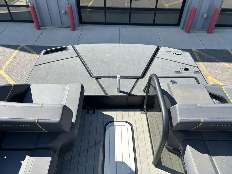 Slide: The Image of 2023 Manitou Explore 22 Max Bench boat interior with seating and deck view. - 24