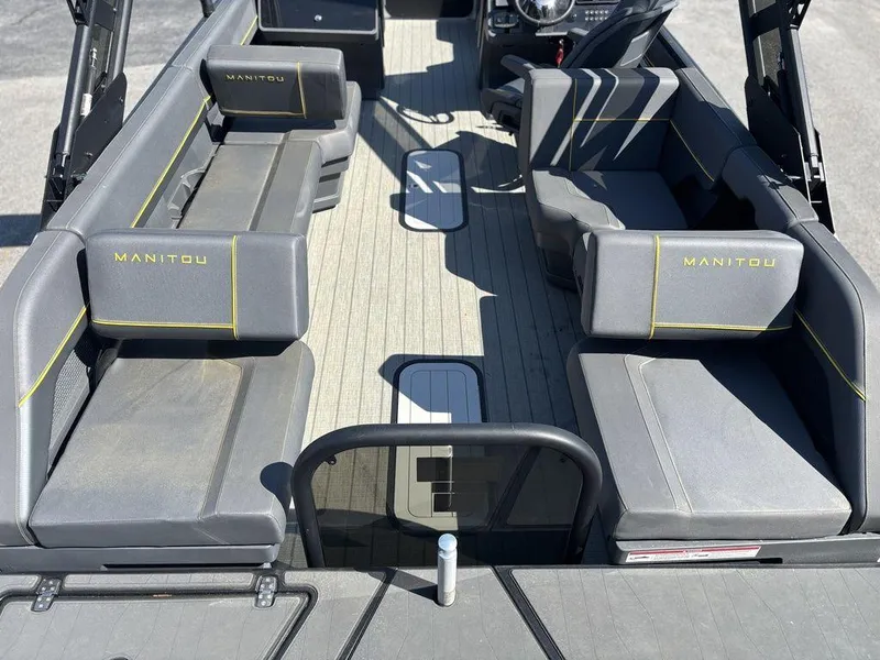 Slide: The Image of 2023 Manitou Explore 22 Max Bench interior with gray seating and yellow accents. - 3