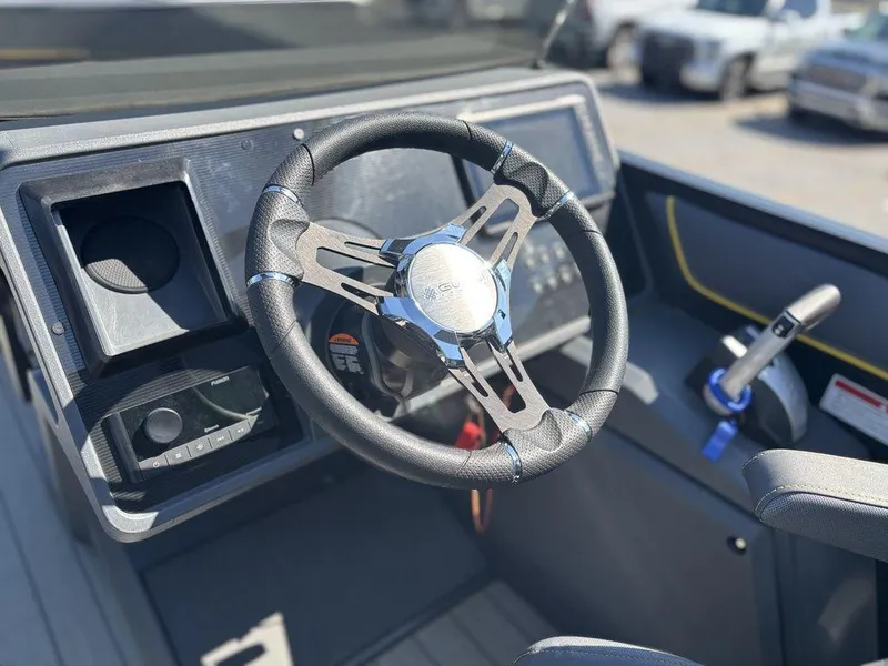 Slide: The Image of 2023 Manitou Explore 22 Max Bench steering wheel and dashboard, featuring modern controls and design. - 9