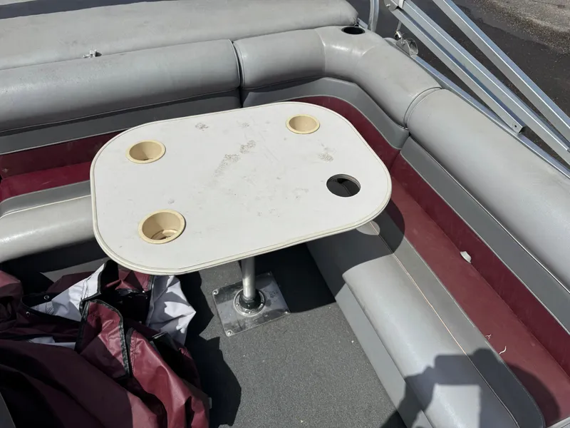 Slide: The Image of Interior of a 2001 Paragon 2200SE boat with a table and seating area. - 11