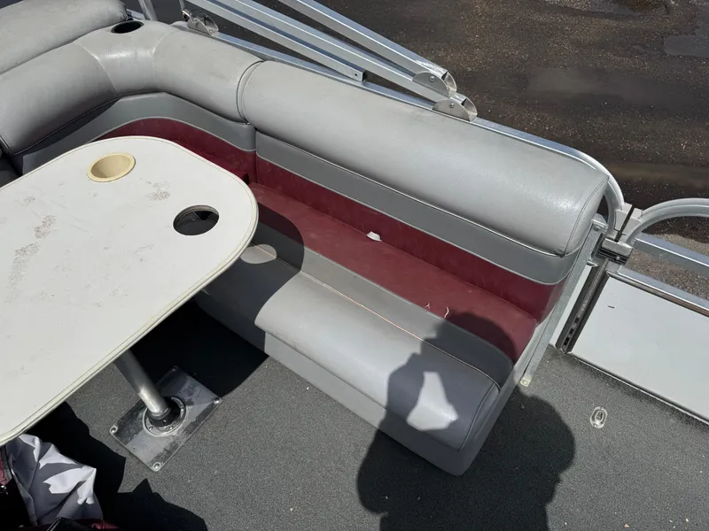 Slide: The Image of Interior of a 2001 Paragon 2200SE boat with seating and table. - 12