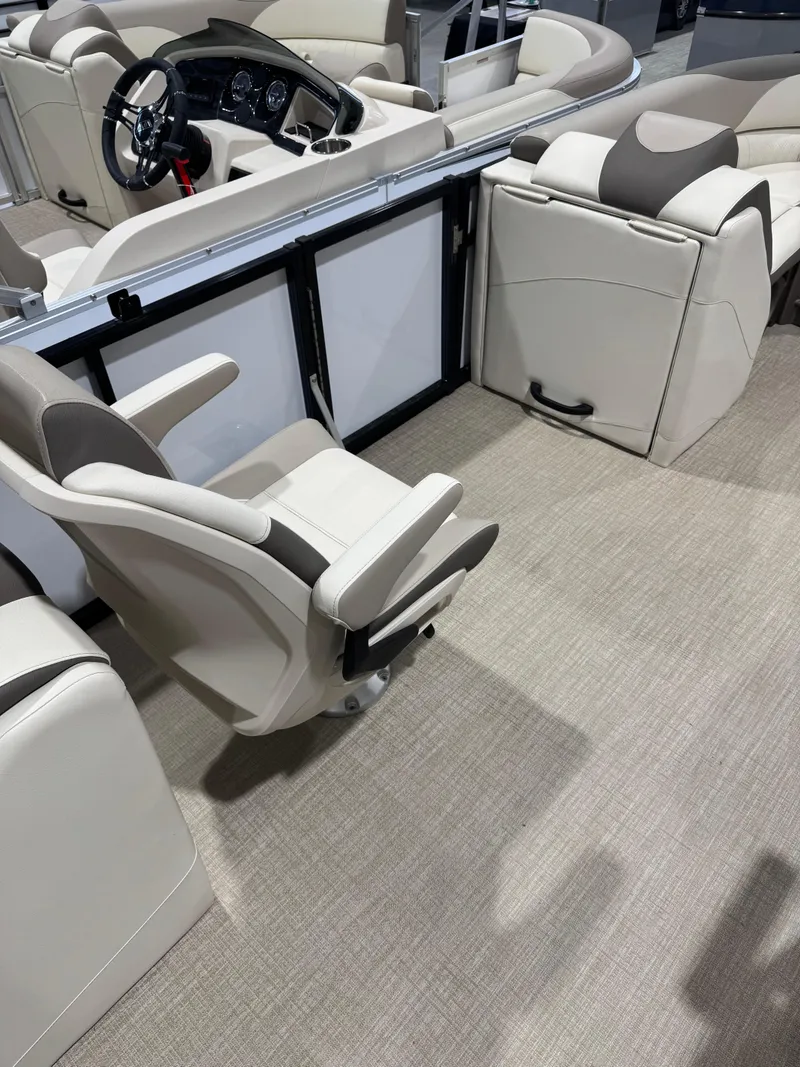 Slide: The Image of 2024 Avalon 2385 25 LSZ QL boat interior with plush seating and modern dashboard. - 8