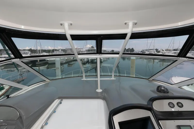 Slide: The Image of 2008 Cruisers Yachts 415 Express Motoryacht helm view with marina backdrop. - 13