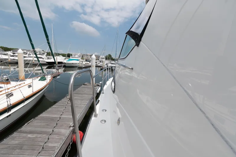 Slide: The Image of 2008 Cruisers Yachts 415 Express Motoryacht docked at marina under blue sky. - 14