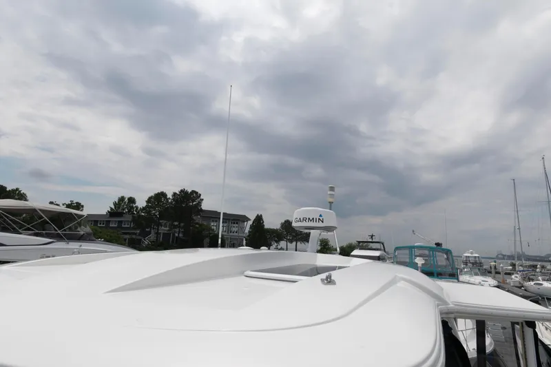 Slide: The Image of 2008 Cruisers Yachts 415 Express Motoryacht with Garmin radar under cloudy sky. - 16