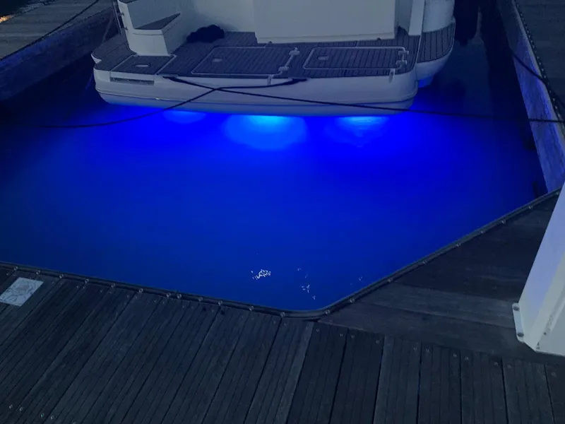 Slide: The Image of 2008 Cruisers Yachts 415 Express Motoryacht with blue underwater lights at dock. - 17