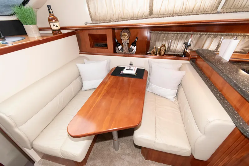 Slide: The Image of 2008 Cruisers Yachts 415 Express Motoryacht interior with cozy dining area and elegant wood finish. - 21