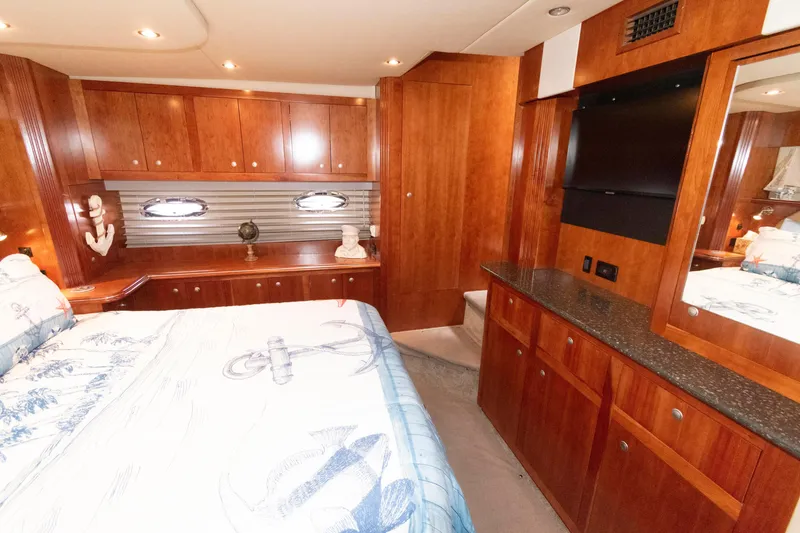 Slide: The Image of Luxurious 2008 Cruisers Yachts 415 Express Motoryacht bedroom with wood cabinetry and nautical decor. - 24