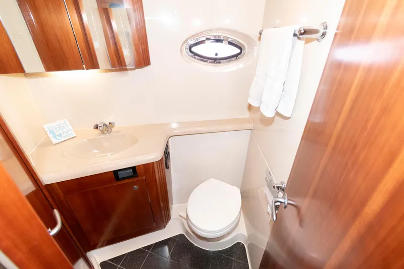 Slide: The Image of Luxurious bathroom in 2008 Cruisers Yachts 415 Express Motoryacht with wood cabinetry and modern fixtures. - 27