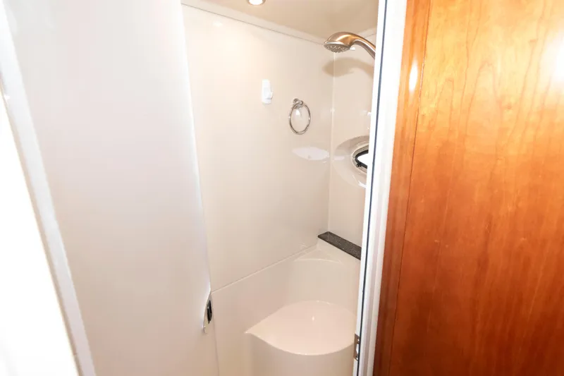 Slide: The Image of 2008 Cruisers Yachts 415 Express Motoryacht bathroom with shower and wooden door. - 28