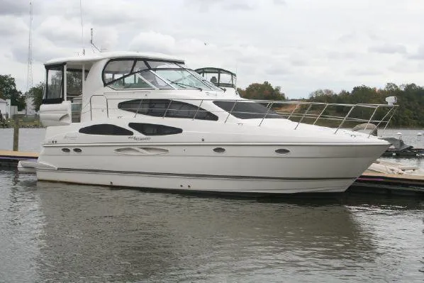 Slide: The Image of 2008 Cruisers Yachts 415 Express Motoryacht docked on calm water. - 4