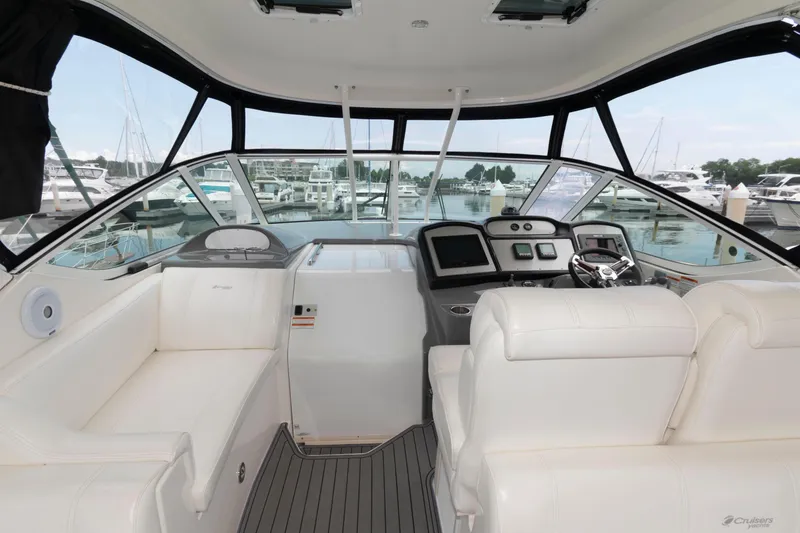 Slide: The Image of 2008 Cruisers Yachts 415 Express Motoryacht cockpit with white seating and marina view. - 7