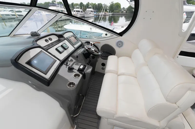 Slide: The Image of 2008 Cruisers Yachts 415 Express Motoryacht helm with modern controls and plush seating. - 8