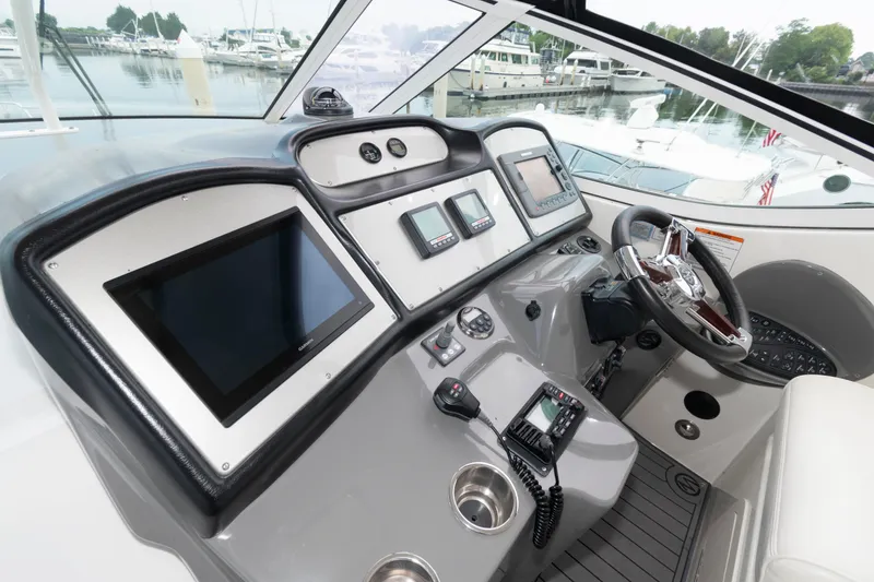 Slide: The Image of 2008 Cruisers Yachts 415 Express Motoryacht helm with modern navigation equipment and controls. - 9