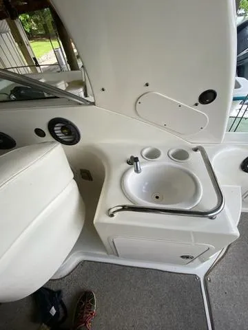Slide: The Image of 2004 Sea Ray 260 Sundancer boat interior with sink and storage area. - 11