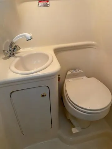 Slide: The Image of 2004 Sea Ray 260 Sundancer bathroom with sink and toilet. - 15