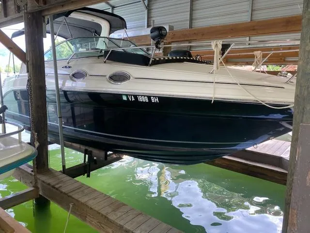 Slide: The Image of 2004 Sea Ray 260 Sundancer boat docked in covered marina. - 17