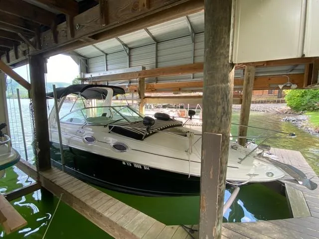 Slide: The Image of 2004 Sea Ray 260 Sundancer docked under a covered marina. - 18
