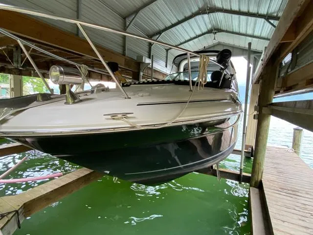 Slide: The Image of 2004 Sea Ray 260 Sundancer boat docked in covered marina, side view. - 20