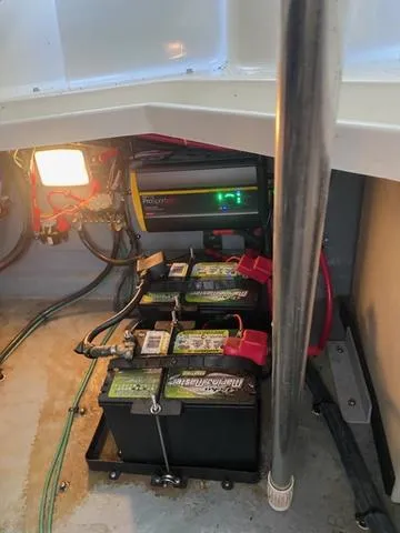 Slide: The Image of 2004 Sea Ray 260 Sundancer battery compartment with charger and wiring. - 4