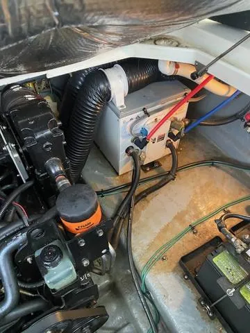 Slide: The Image of Engine compartment of a 2004 Sea Ray 260 Sundancer, showing mechanical components and wiring. - 5