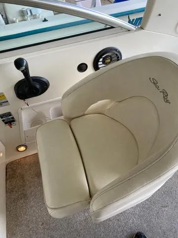 Slide: The Image of 2004 Sea Ray 260 Sundancer helm seat with control panel and steering wheel. - 8