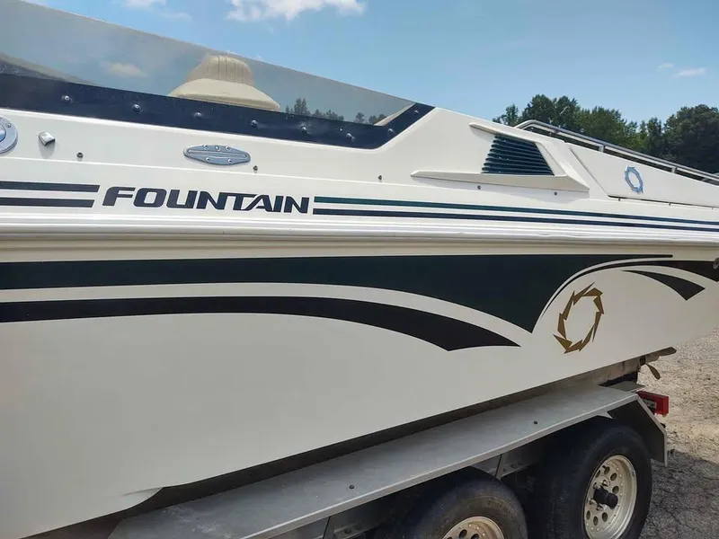 Slide: The Image of 1996 Fountain 32 Fever boat on trailer, featuring sleek design and logo. - 10