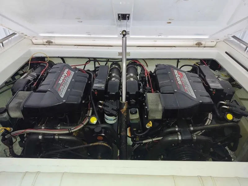 Slide: The Image of Twin engines in a 1996 Fountain 32 Fever boat, showcasing powerful marine performance. - 3