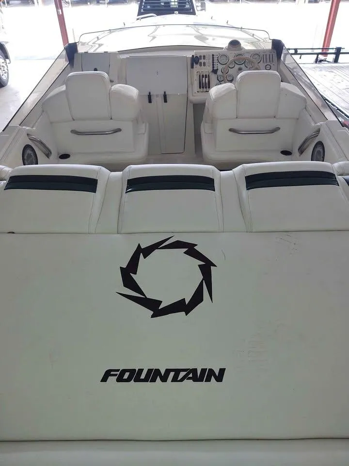 Slide: The Image of 1996 Fountain 32 Fever boat interior with white seating and dashboard. - 5