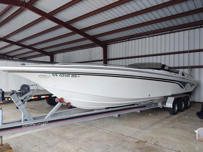Slide: The Image of 1996 Fountain 32 Fever boat on trailer in covered storage. - 6