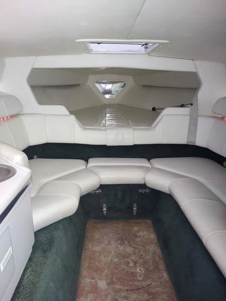 Slide: The Image of Interior of 1996 Fountain 32 Fever boat with white seating and compact cabin design. - 7