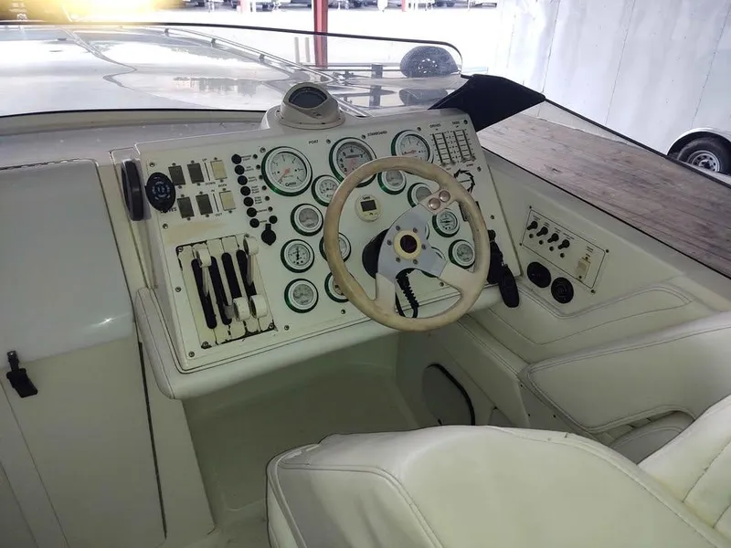 Slide: The Image of 1996 Fountain 32 Fever boat dashboard with gauges and steering wheel. - 9