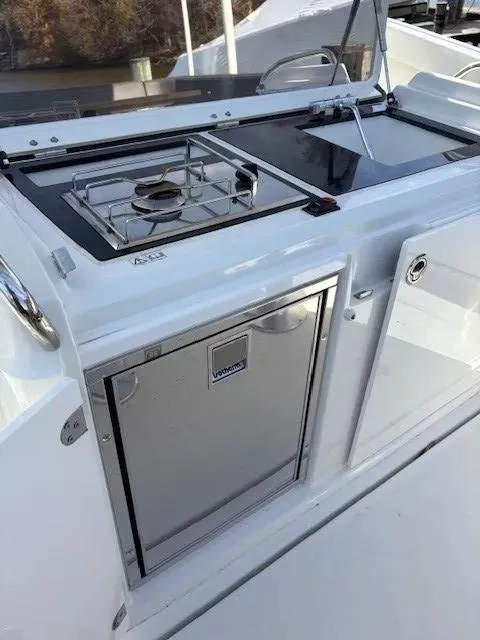 Slide: The Image of 2020 Jeanneau Leader 9.0 CC boat kitchen with stove and fridge. - 16