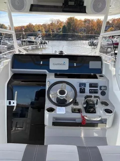 Slide: The Image of 2020 Jeanneau Leader 9.0 CC helm with Garmin navigation, docked at marina. - 18