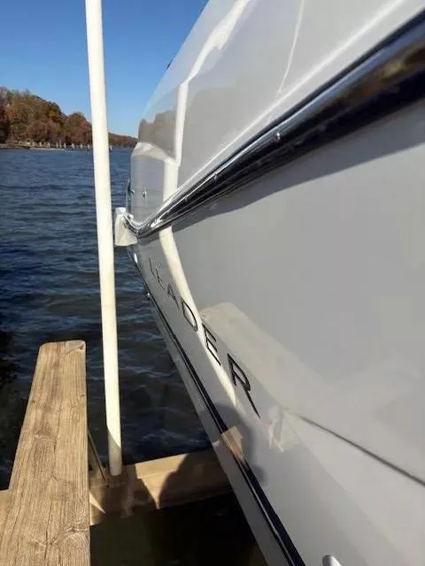 Slide: The Image of 2020 Jeanneau Leader 9.0 CC boat docked by a lake. - 6