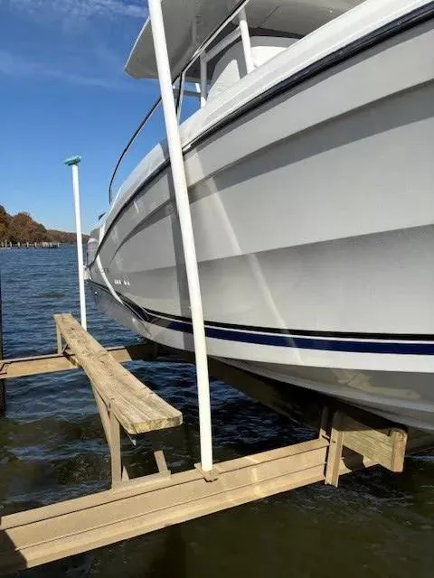 Slide: The Image of 2020 Jeanneau Leader 9.0 CC boat docked on a lift over water. - 7