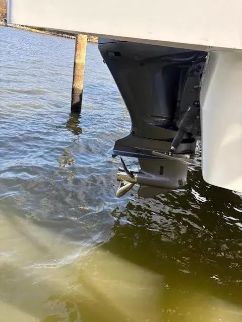 Slide: The Image of Outboard motor of 2020 Jeanneau Leader 9.0 CC on water. - 9