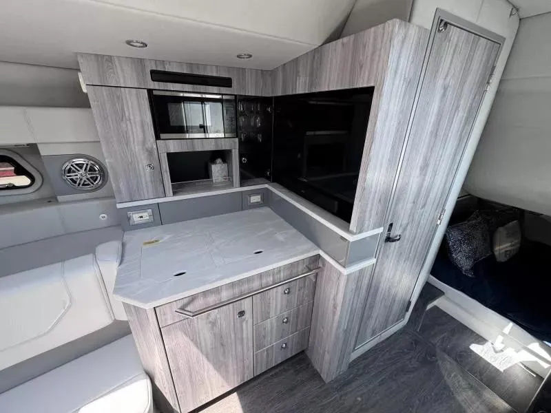Slide: The Image of 2020 Formula 430 Super Sport Crossover interior with modern kitchenette and sleek cabinetry. - 14