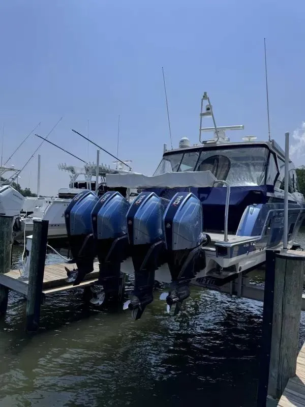 Slide: The Image of 2020 Formula 430 Super Sport Crossover boat with four powerful outboard engines docked. - 4