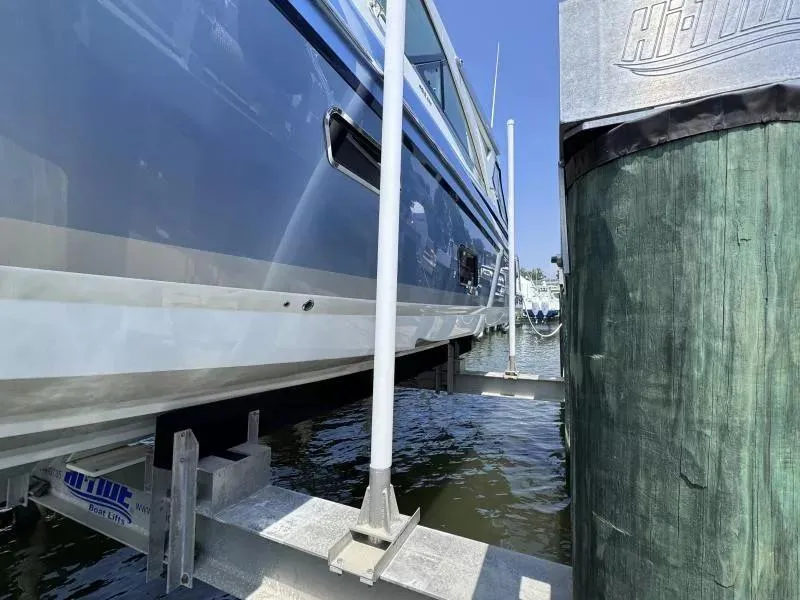 Slide: The Image of 2020 Formula 430 Super Sport Crossover on boat lift at marina. - 6