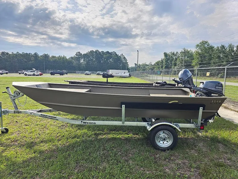 Slide: The Image of 2025 G3 Gator Tough 1548 VBW boat on trailer, parked on grass under cloudy sky. - 0