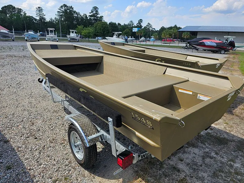 Slide: The Image of 2025 G3 Gator Tough 1548 VBW boat on trailer, parked outdoors. - 13